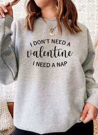 Side view of person wearing black sweatshirt with 'I Don't Need A Valentine' text.
