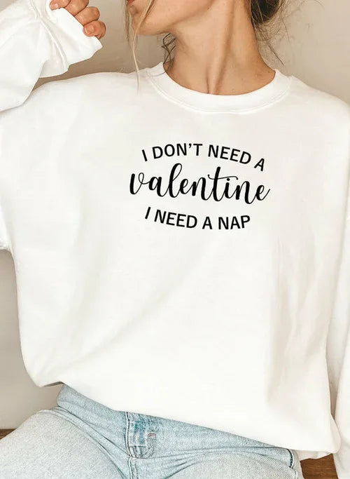 Black sweatshirt shown flat with white 'I Don't Need A Valentine' text across chest.