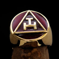 Side view of a polished solid brass Masonic pinky ring showcasing red enamel detail.