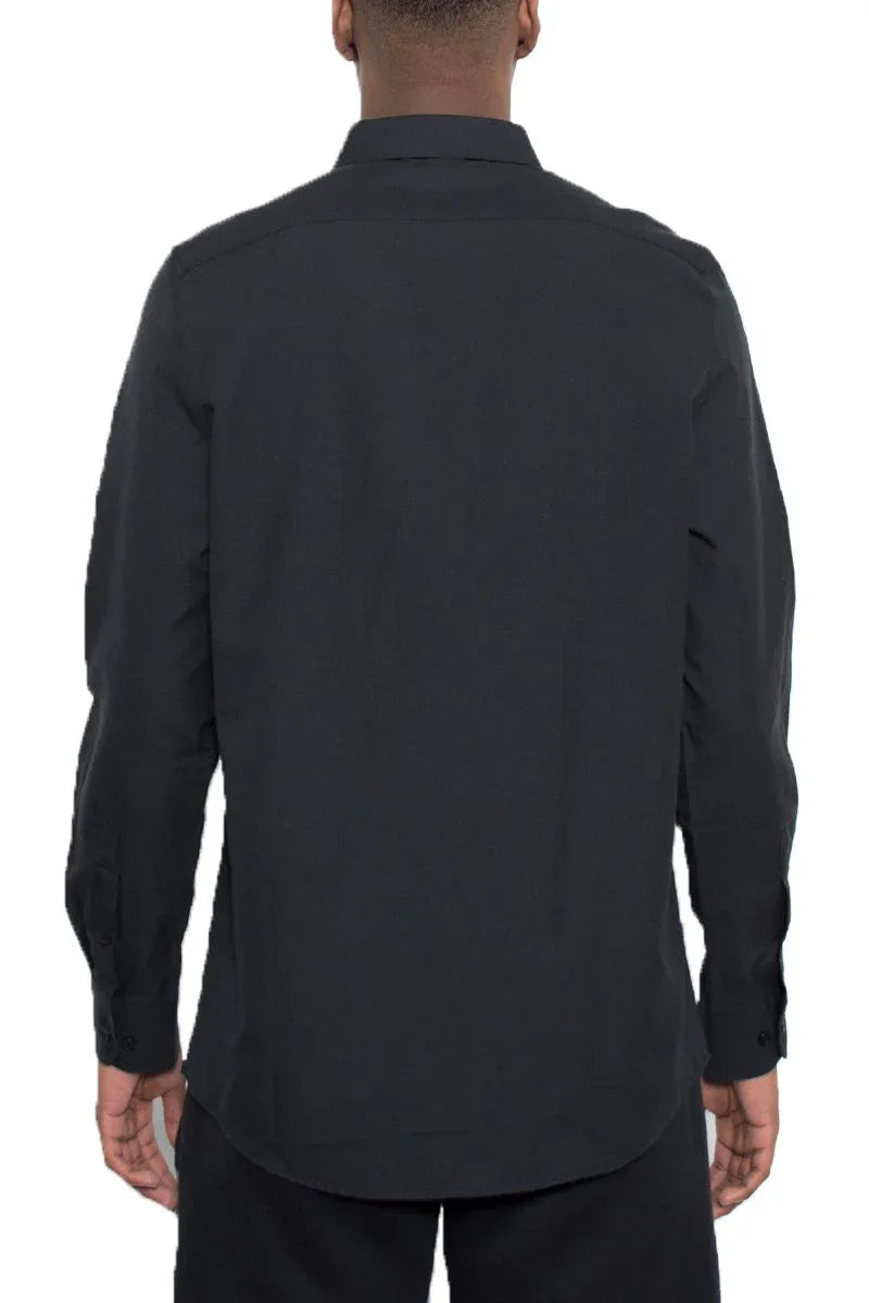 Close-up of men's black long sleeve shirt sleeve and cuff showing button detail.