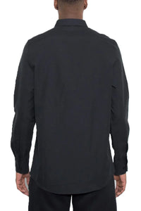 Close-up of men's black long sleeve shirt sleeve and cuff showing button detail.