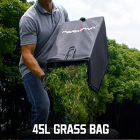 Cordless lawn mower cutting grass in a backyard setting with green lawn
