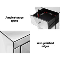 Mirrored bedside table positioned beside bed, reflecting room space and décor.