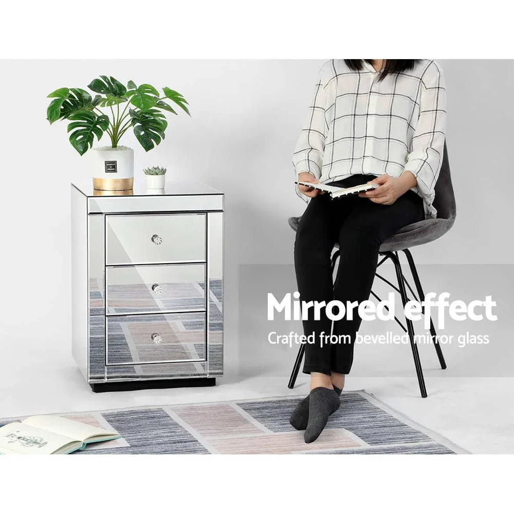 Side angle of mirrored bedside table highlighting elegant design and mirrors on all sides.