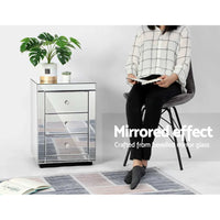 Side angle of mirrored bedside table highlighting elegant design and mirrors on all sides.