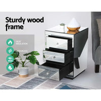 Three drawers of mirrored bedside table partially open showing ample storage.