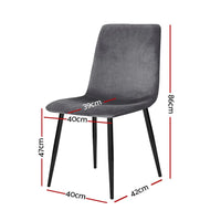 Close-up of grey velvet upholstered modern dining chair with solid iron legs on wooden floor.