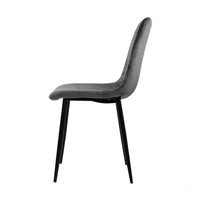 Back view of grey velvet dining chair highlighting curved backrest and iron legs.