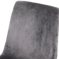 Set of four modern dining chairs with grey velvet seats and black iron legs grouped together.