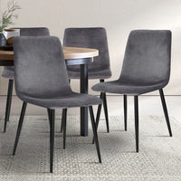 Modern grey velvet dining chair highlighting anti-slip floor protectors on iron legs.