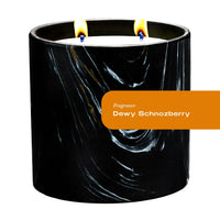 Close-up of Dewy Schnozberry candle in black and white marquina ceramic vessel with gold swirls.