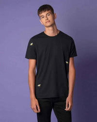 Model wearing black t-shirt with embroidered bee design on chest and back.