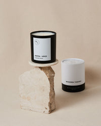 Close-up of the SANTAL + SPICE candle’s label highlighting its natural ingredients and clean design.