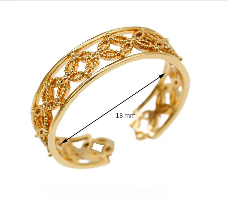 Detailed view of slim, adjustable gold ring with polished finish on neutral backdrop