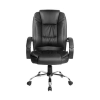 Close-up of padded headrest and backrest of the black leather office chair showing stitching detail.