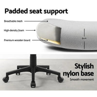 Office chair positioned at desk with ergonomic design and padded seat.