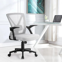 Close-up of mesh fabric on office chair’s backrest and cushioned seat.
