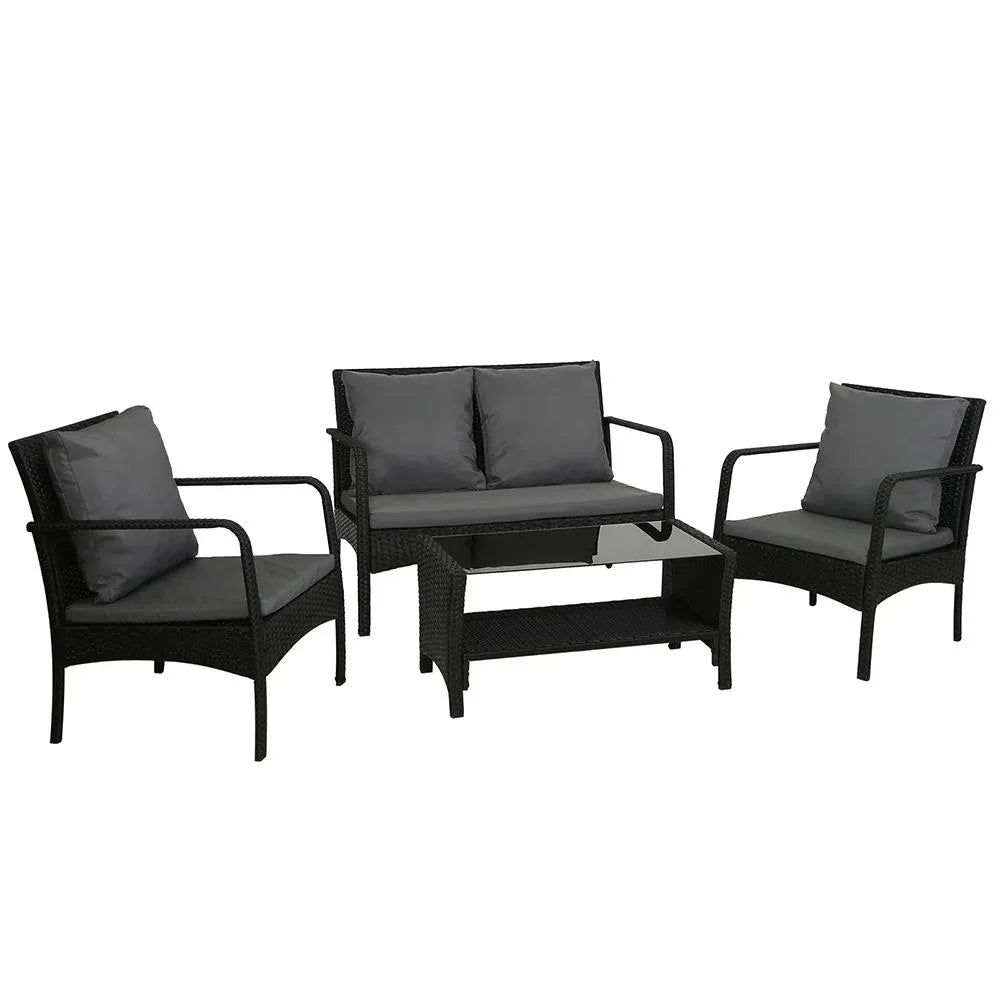 Black wicker outdoor lounge set with two armchairs, two-seater sofa, and glass-top table on wooden deck.