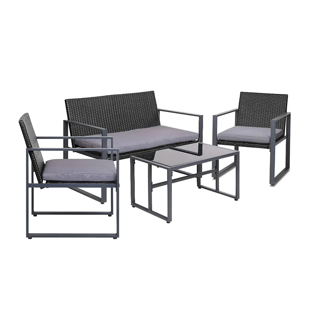 Black four-piece outdoor patio furniture set with table and cushioned chairs on patio.