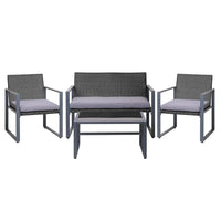 Black outdoor table with tempered glass top and modern square design in patio setting.