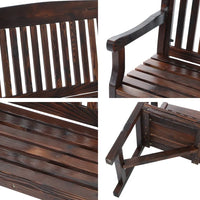 Natural outdoor wooden bench placed near garden plants with classic rustic design