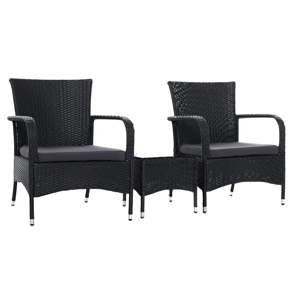 Outdoor conversation set with two black wicker chairs and a matching small table on a patio.