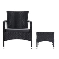 Close-up of black wicker table and chairs with powder-coated steel frame on patio floor.