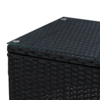 Black wicker chair with high-density cushions angled towards matching outdoor table.