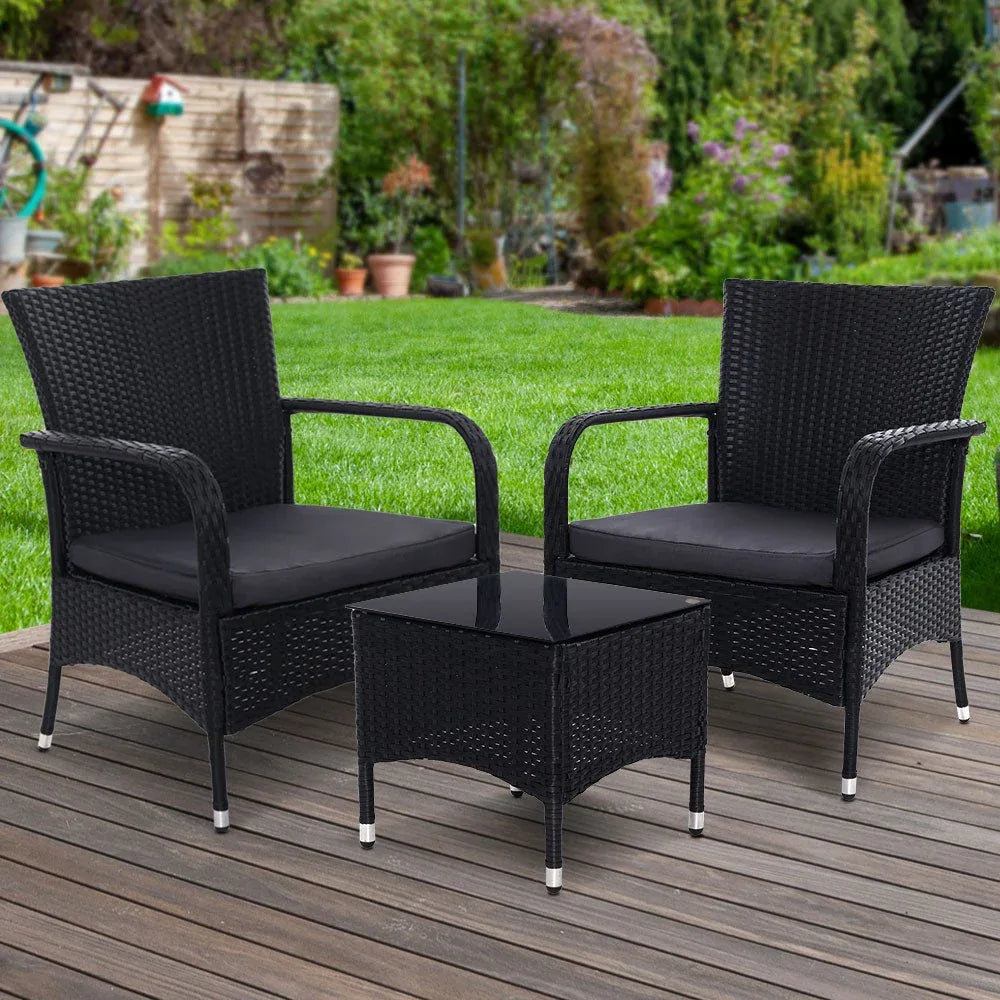 Wicker patio set including two chairs and small table under bright natural light.