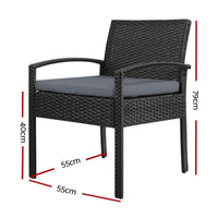 Close-up of black wicker armchair with padded seat cushion and sturdy steel frame