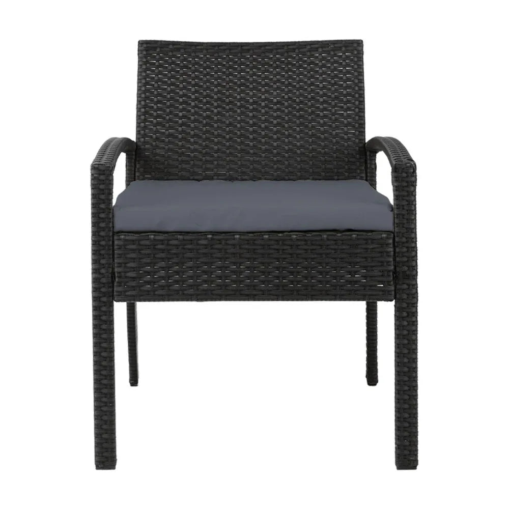 Profile view of black wicker outdoor chair showing curved armrests and cushion