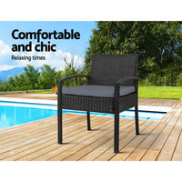 Detailed view of black powder-coated steel chair legs supporting wicker seat
