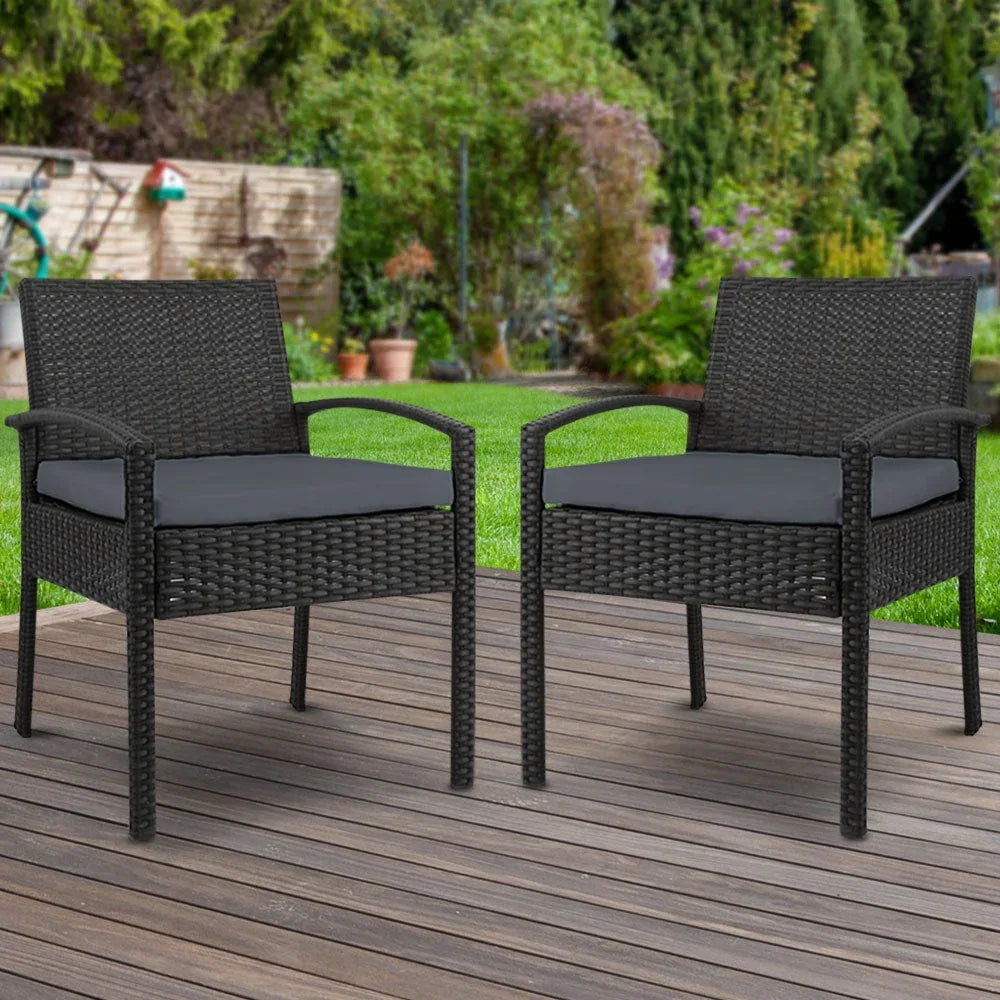 Back angle of black wicker outdoor chair showing woven design and padded cushion