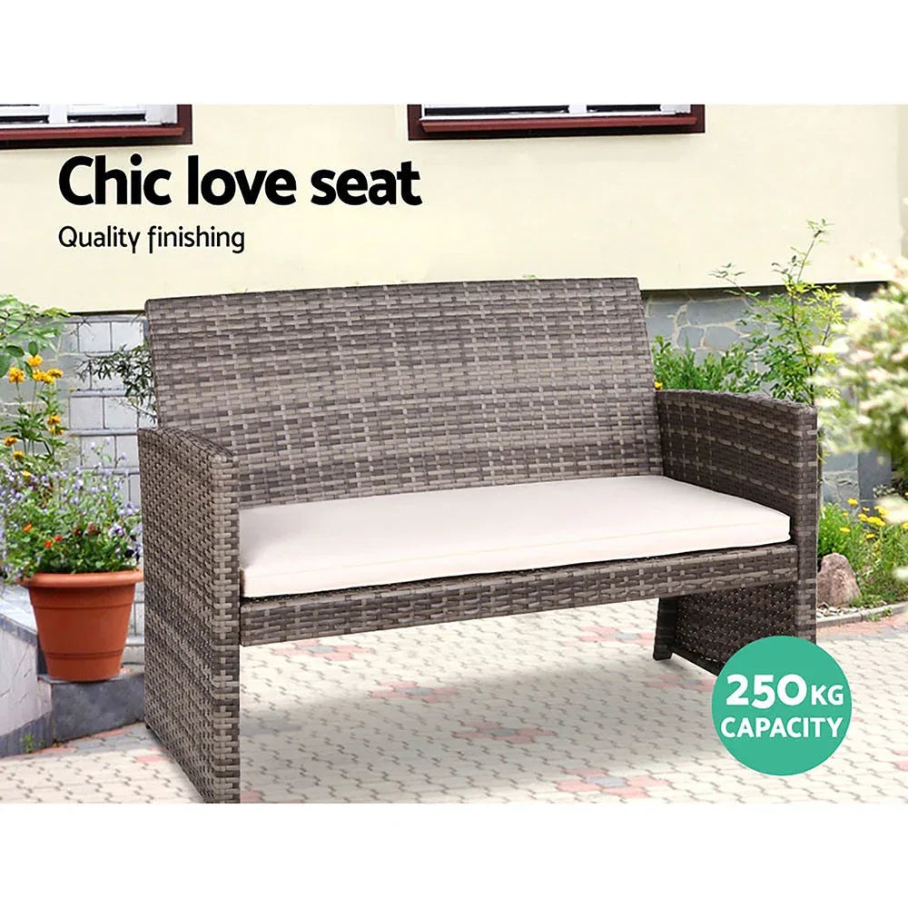 Side view of rattan armchair with gray removable cushions, showcasing sturdy steel frame underneath.