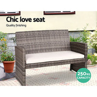 Side view of rattan armchair with gray removable cushions, showcasing sturdy steel frame underneath.
