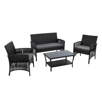 Black 4-piece outdoor wicker furniture set with cushions arranged on patio under greenery.