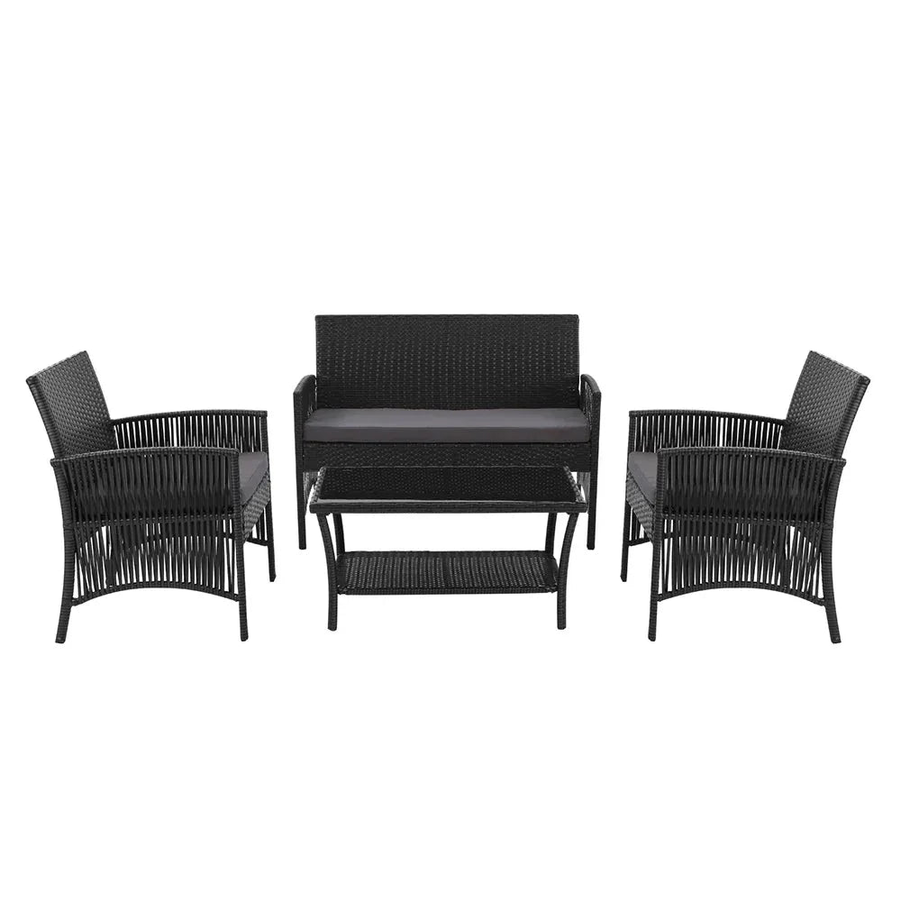 Side view of black wicker chair with thick cushioned seat in outdoor setting.