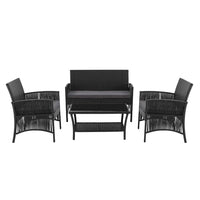 Side view of black wicker chair with thick cushioned seat in outdoor setting.