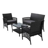 Outdoor lounge chair with black wicker frame and comfortable cushions on patio.