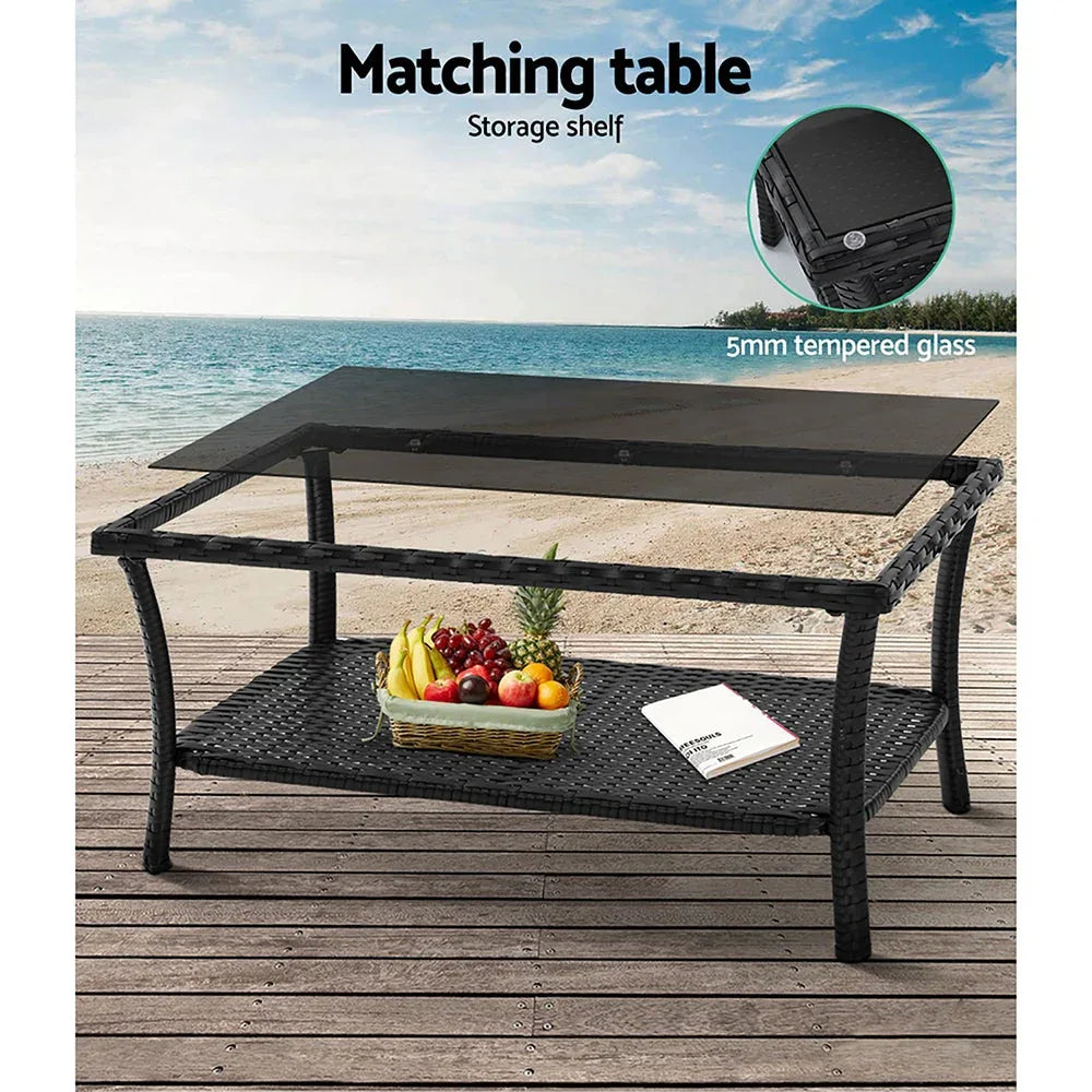 Close shot of outdoor furniture corner with black wicker and thick zippered cushions.