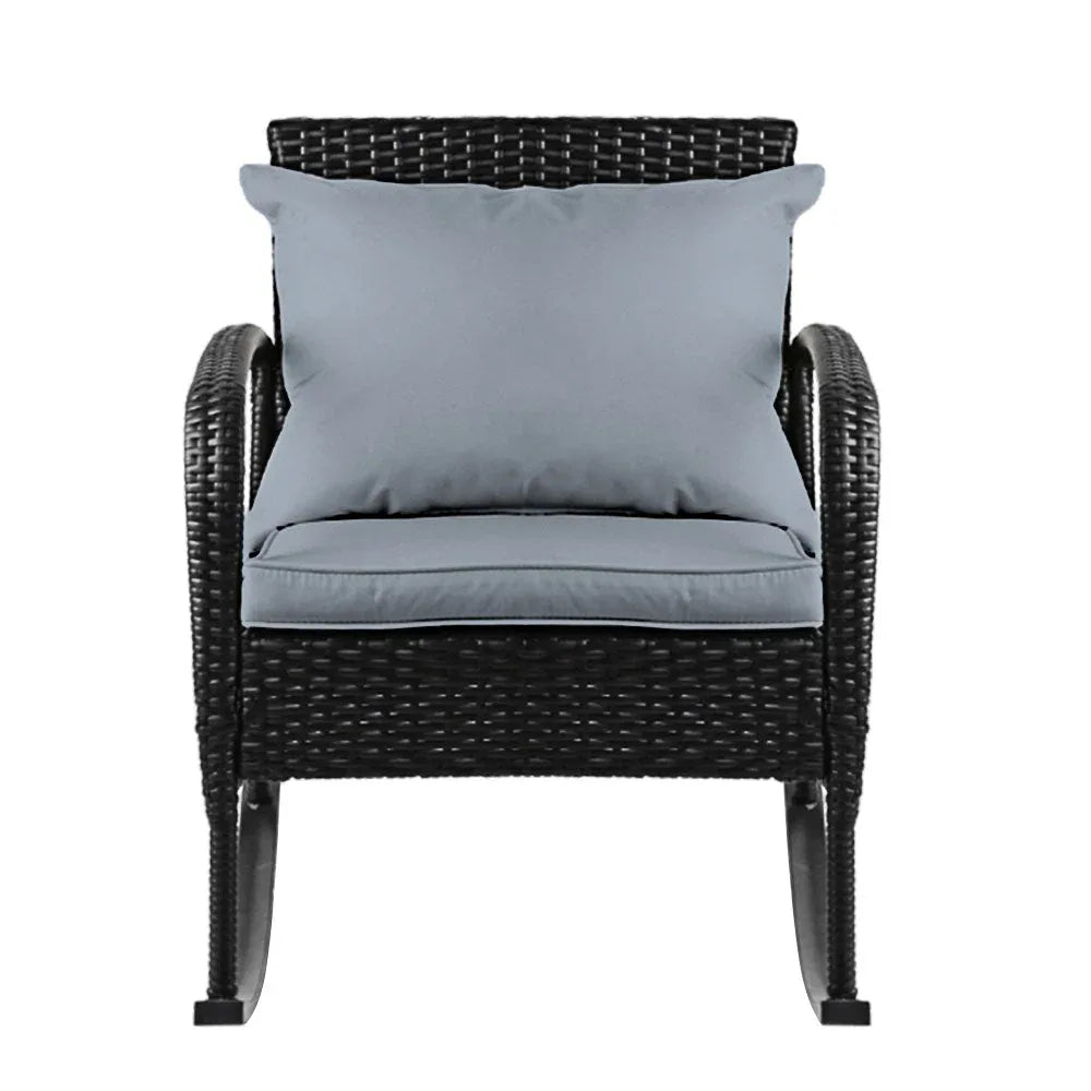 Close-up of the rocking chair's woven wicker texture and plush cushioned seat.