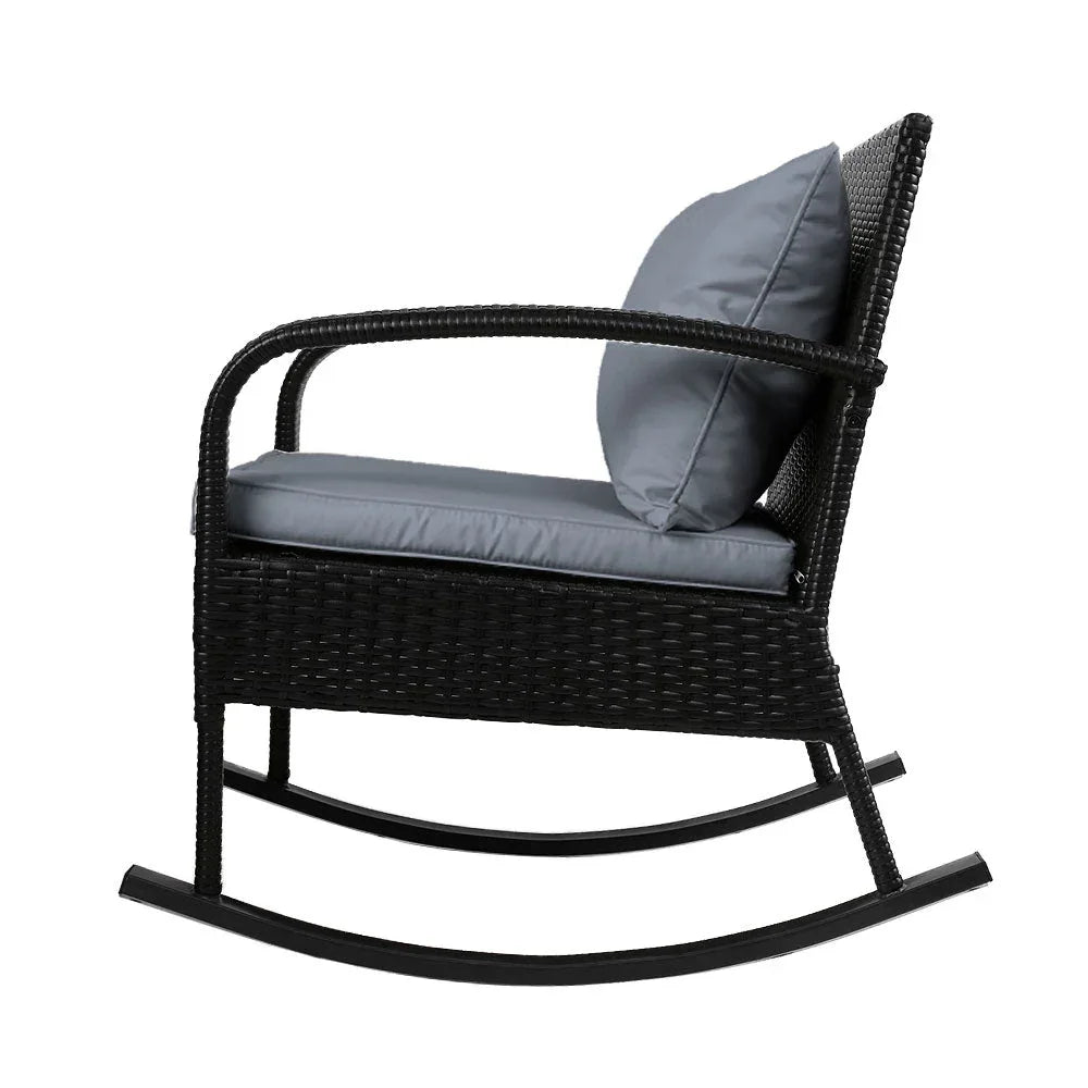 Black wicker rocking chair with removable cushion covers placed on outdoor patio.