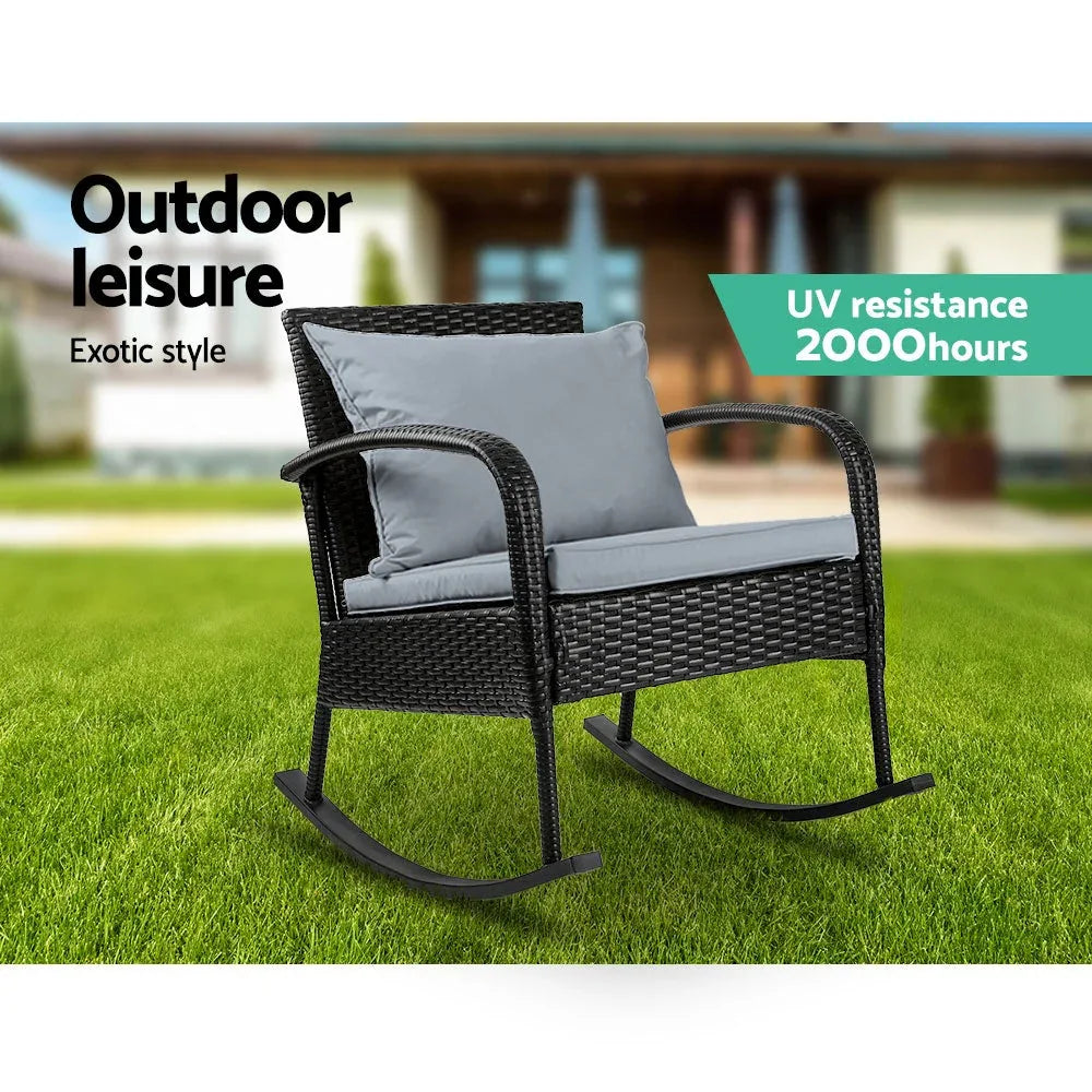 Close detail of the chair’s armrest and cushioned pillow in an outdoor garden setting.