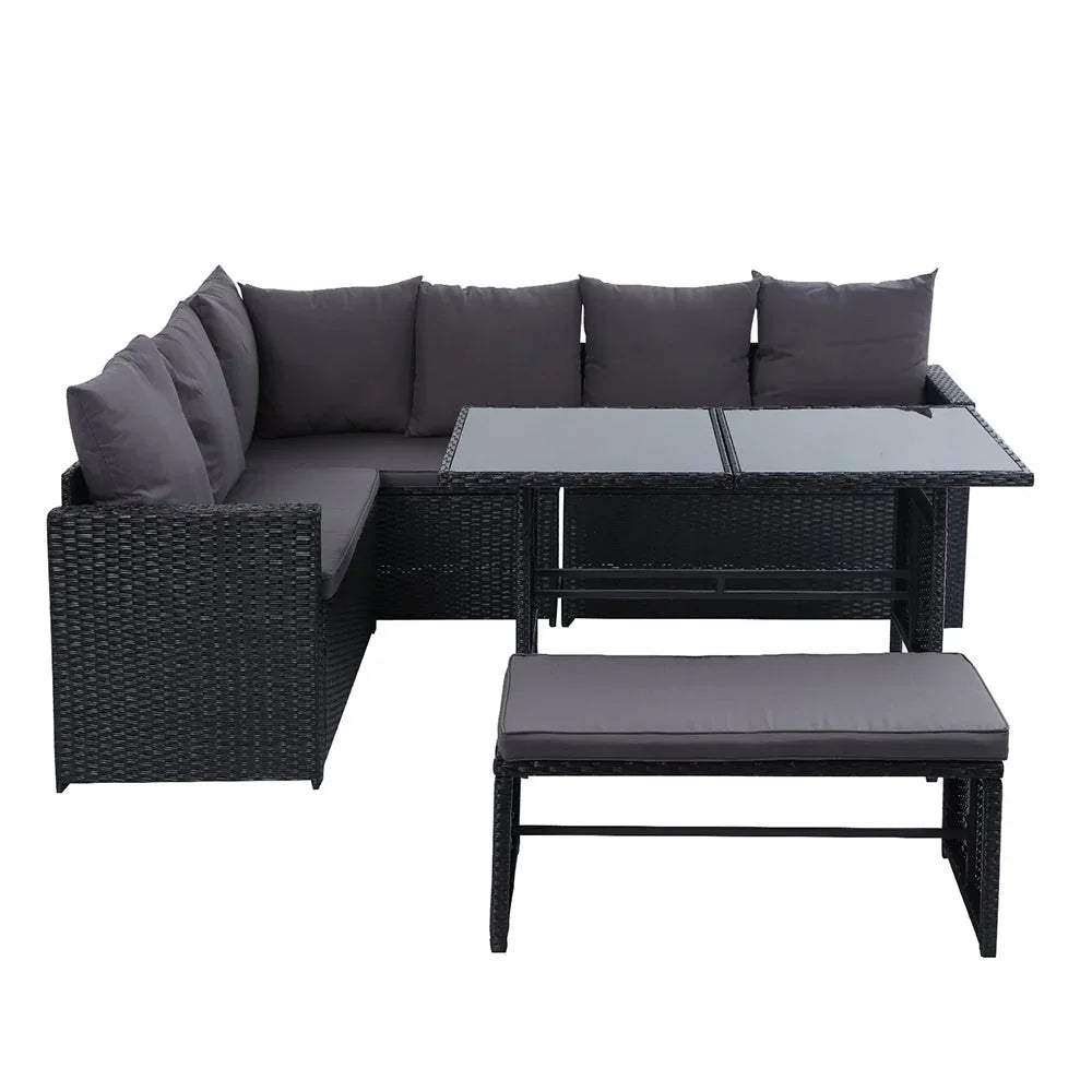 Top view of modular wicker sofa sections arranged outdoors on stone patio.