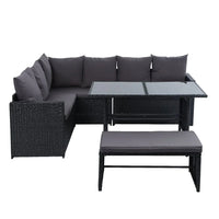Top view of modular wicker sofa sections arranged outdoors on stone patio.
