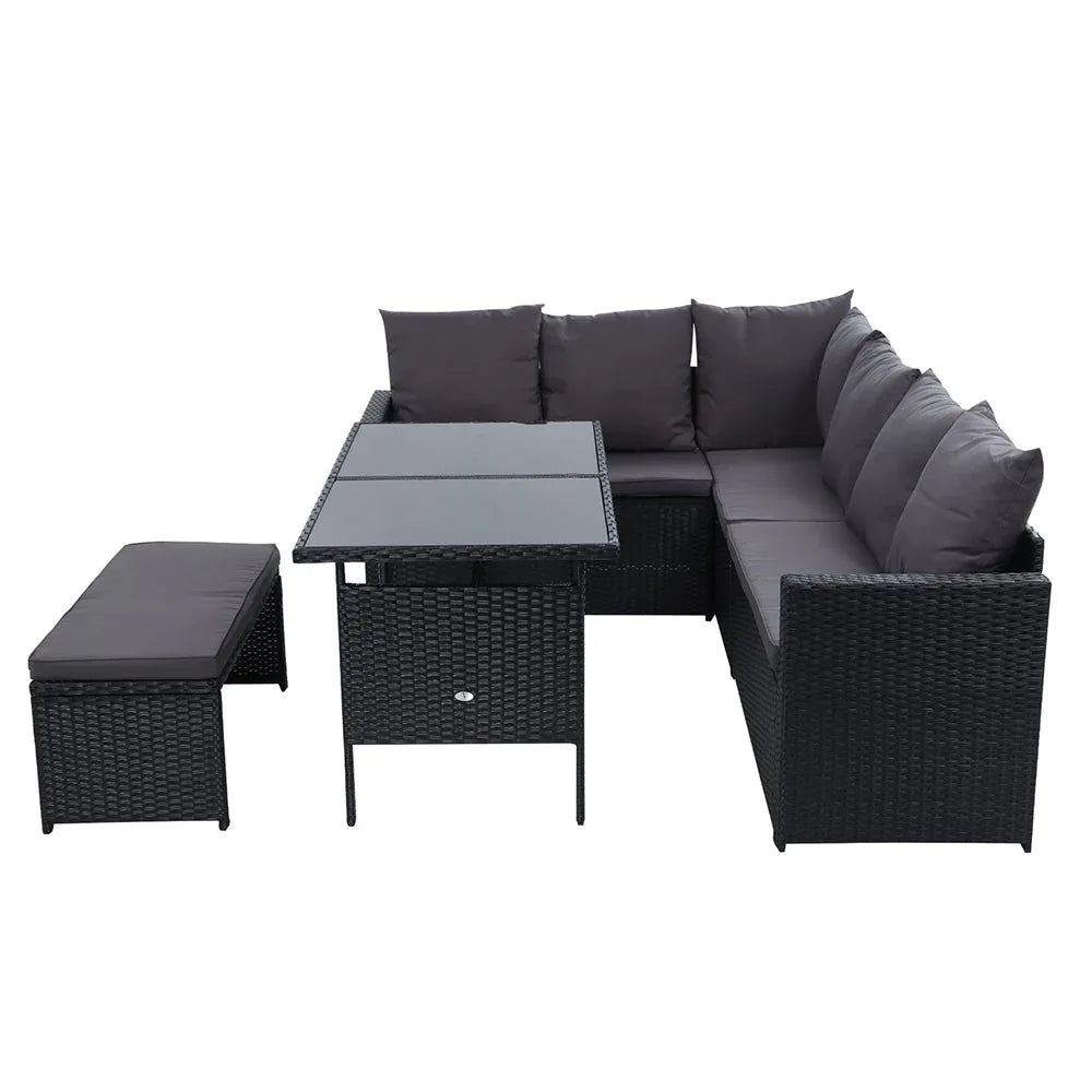 Side angle of outdoor sofa showing black wicker weaving and plush cream cushions.