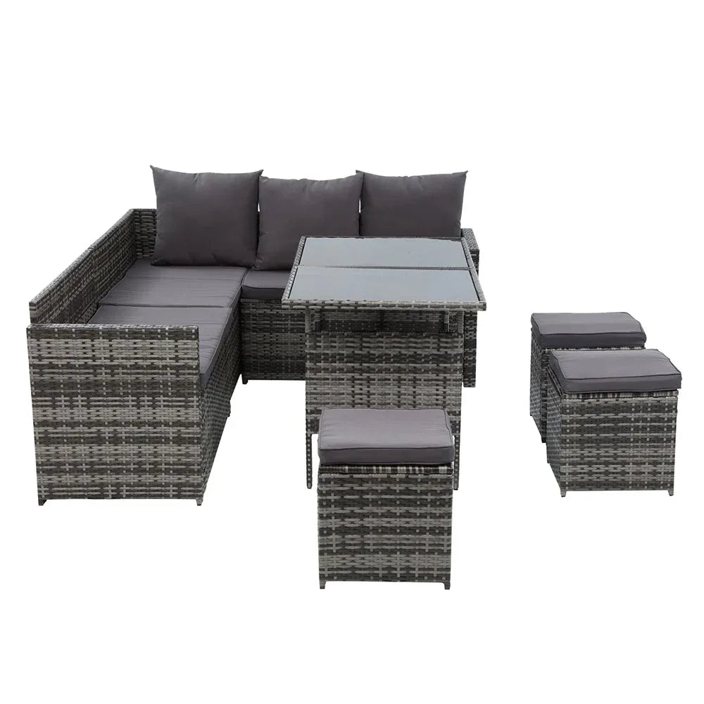 Corner arrangement of wicker sofa with light cushions under bright sunlight.