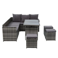 Corner arrangement of wicker sofa with light cushions under bright sunlight.