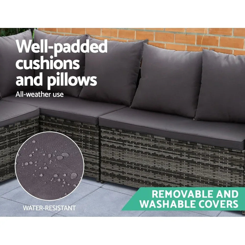 Wicker sofa set arranged with table, showing seat hooks securing cushions.