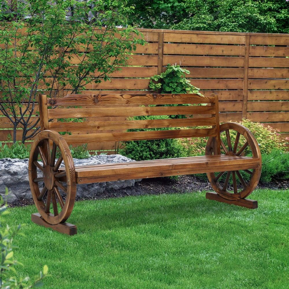 Rustic wooden garden bench with wagon wheel armrests on outdoor concrete surface